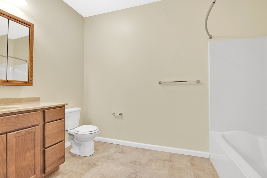 A bathroom with a toilet, a sink, and a bathtub.
