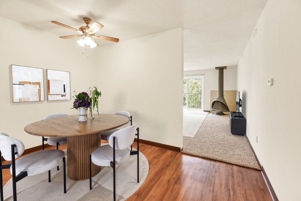 A dining room with a round table and chairs.