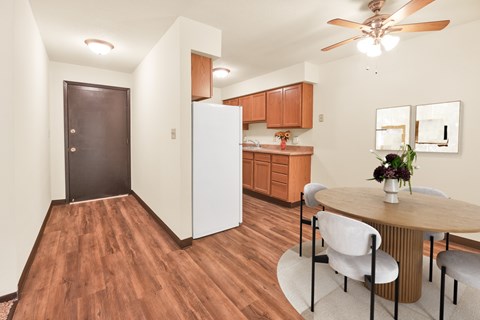 A kitchen with a table and chairs.