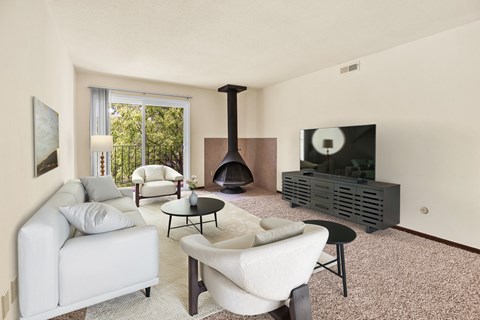 A living room with a fireplace and a television. at Indian Ridge Apartments, Davenport, IA