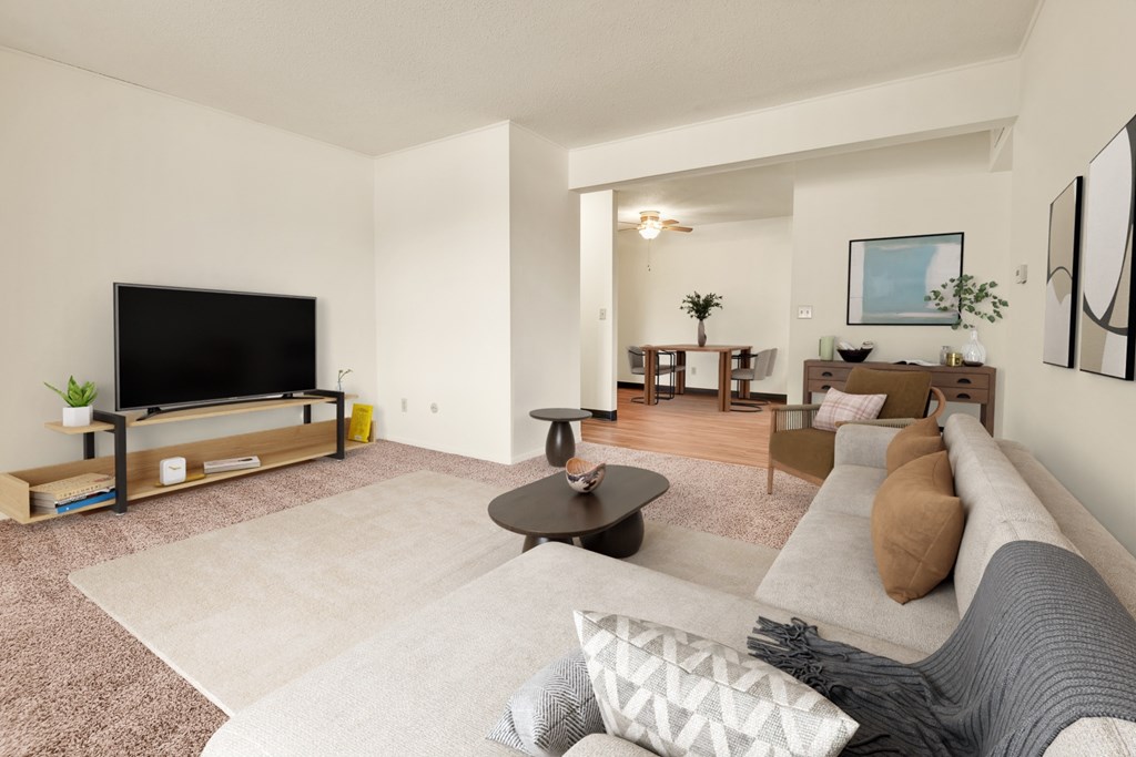 A living room with a flat screen TV and a coffee table.