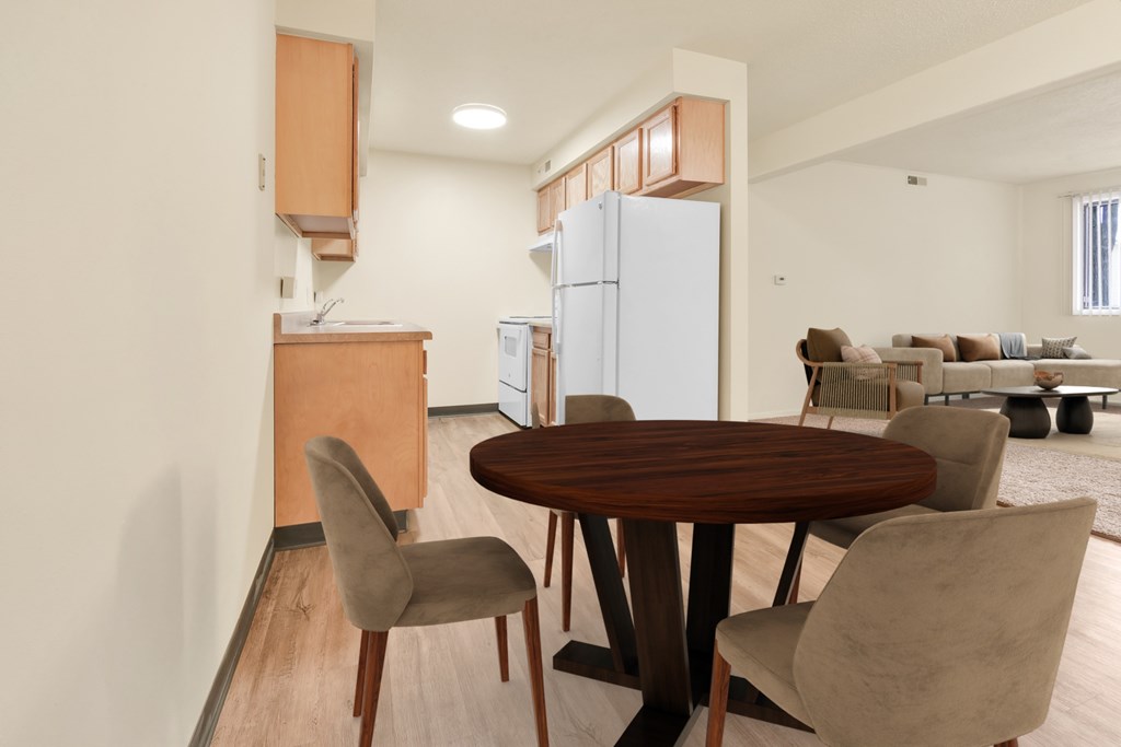 A modern dining room with a round wooden table and chairs.