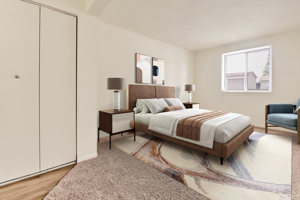 A bedroom with a bed, nightstand, and chair.