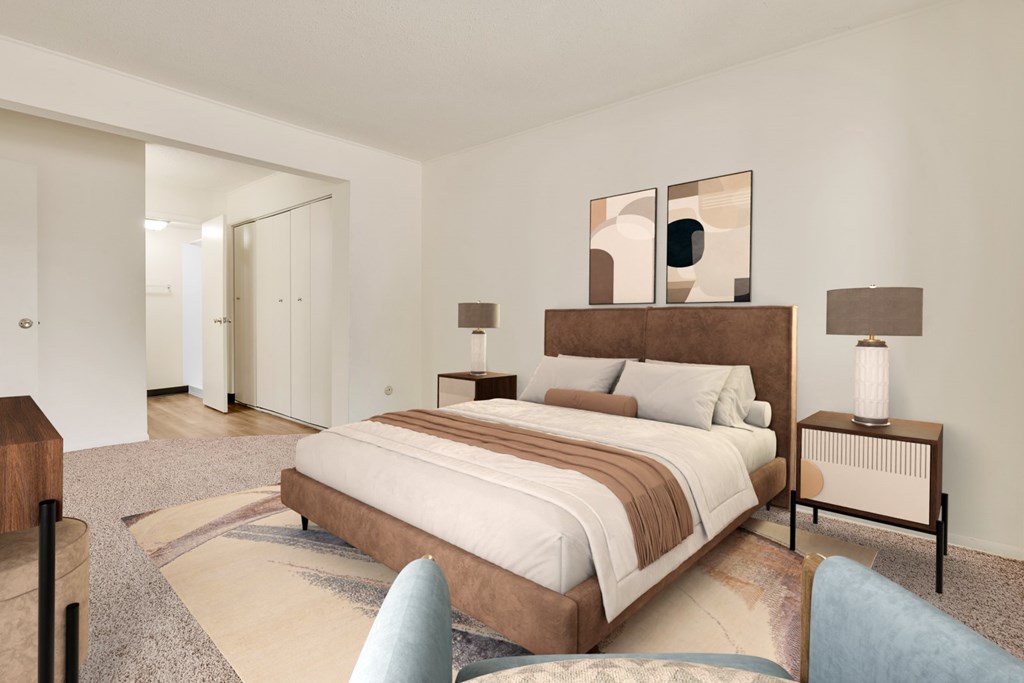 A bedroom with a large bed and a mirror on the wall.