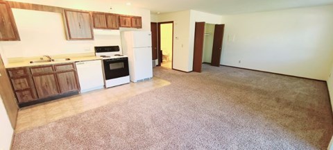 A kitchen with white appliances and wooden cabinets at Windsor Crest Apartments, Davenport , Iowa
