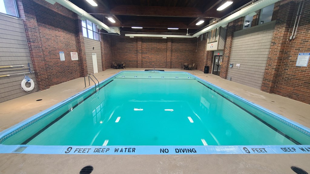 a large indoor swimming pool with the words 9 feet deep water no diving