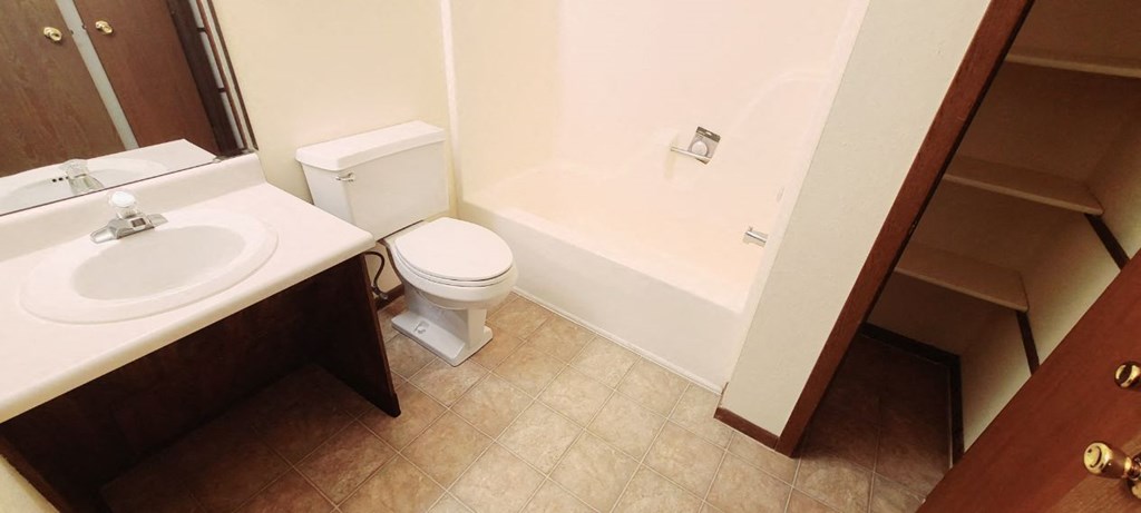 a bathroom with a toilet and a sink and a bath tub