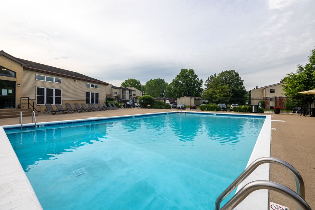 A large swimming pool with a metal ladder on the side.