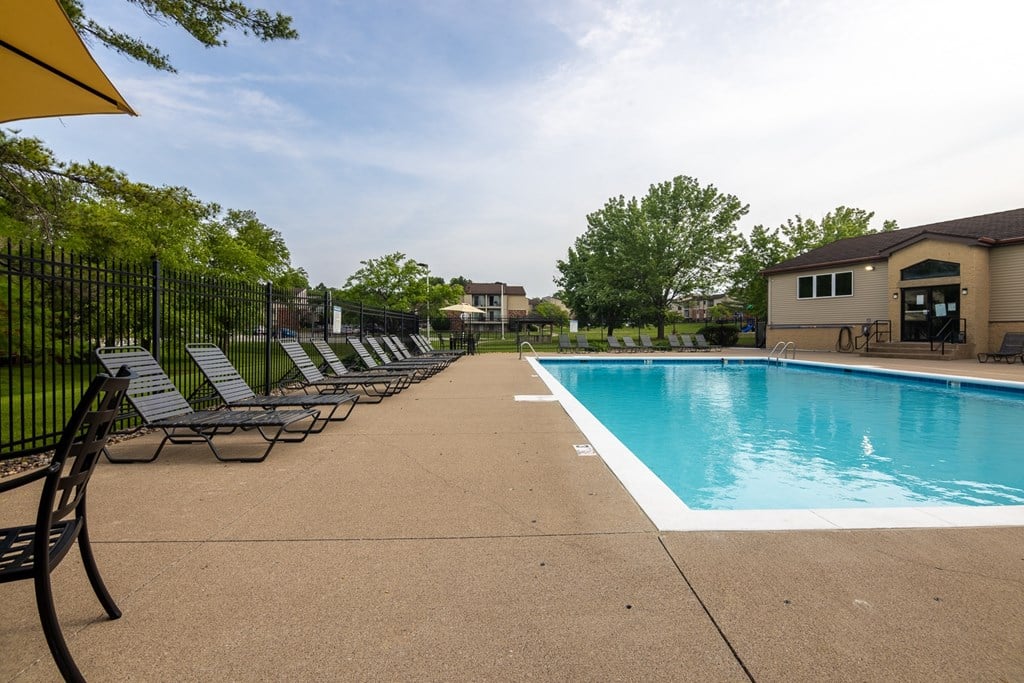 A pool with chairs around it.