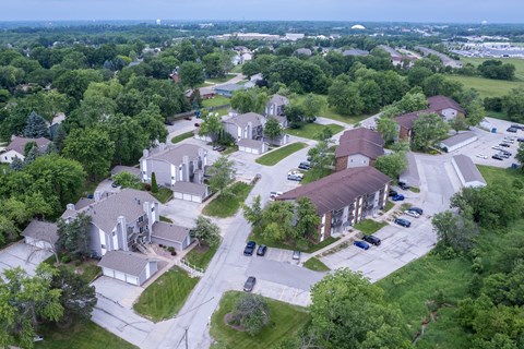 A bird's eye view of a residential area with houses and cars.