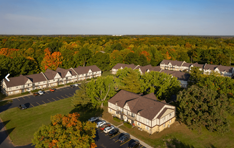 A large building surrounded by trees in the fall.