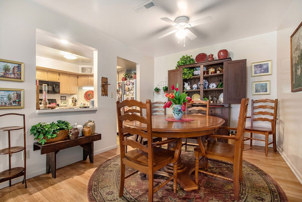 a dining room with a wooden table and chairs