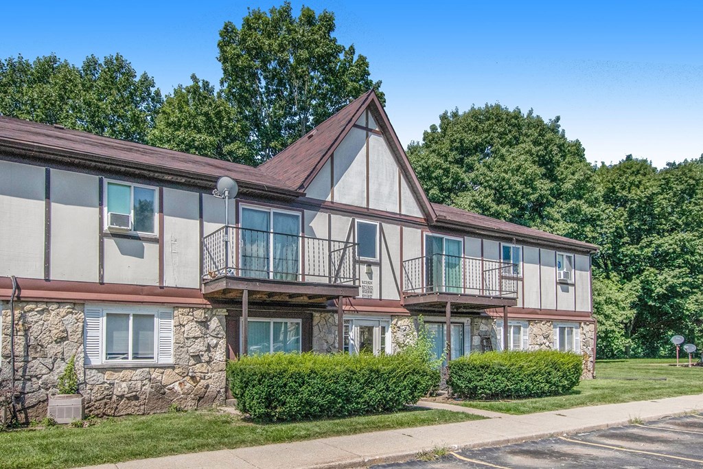 the front of a house with trees in the background
