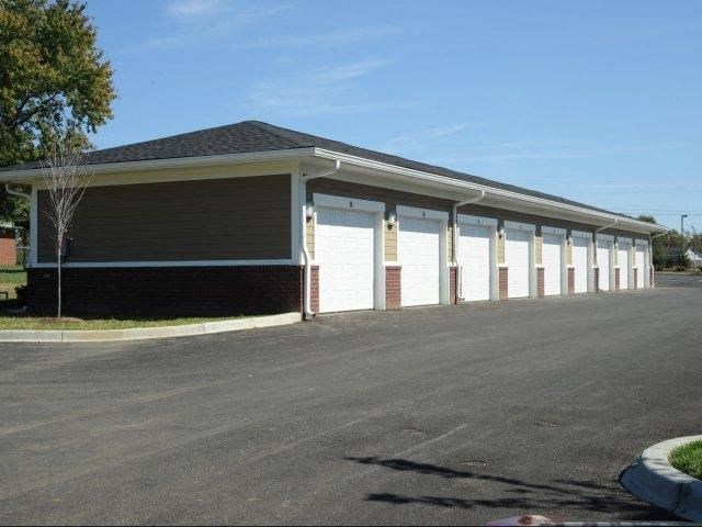 a building with white garage doors and a parking lot