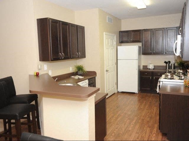 a kitchen with a counter and a refrigerator