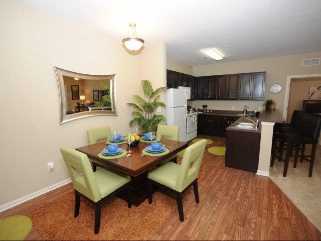 a dining room and kitchen with a table and chairs