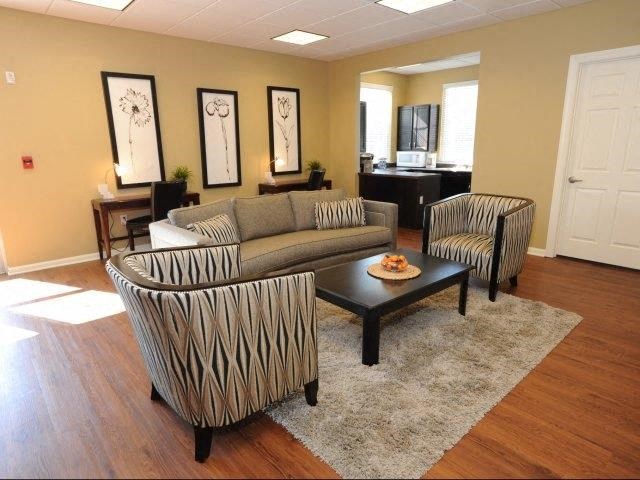 a living room with a couch and two chairs