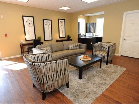 a living room with a couch and two chairs