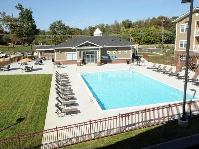 an aerial view of a swimming pool with chairs