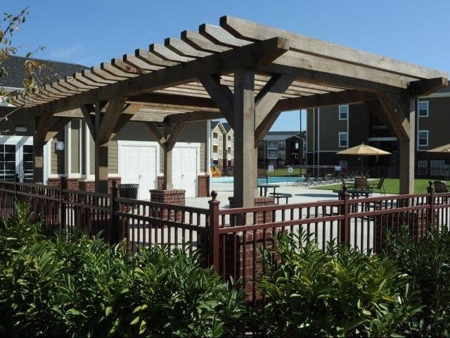 a patio with a pavilion and a pool