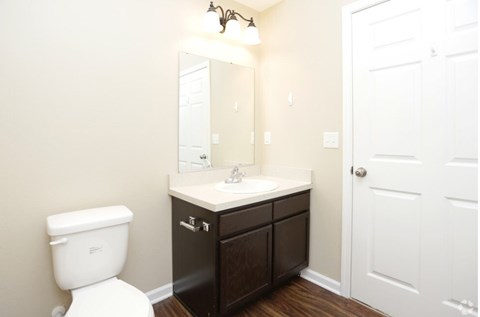 A white toilet sits next to a sink in a bathroom.