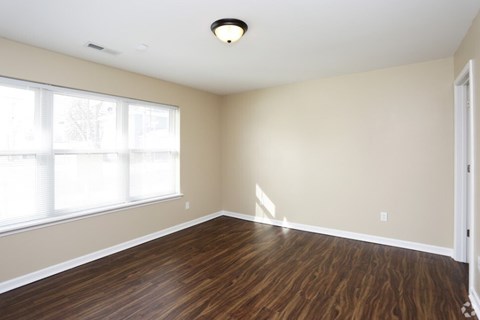 A room with wooden floors and a window.
