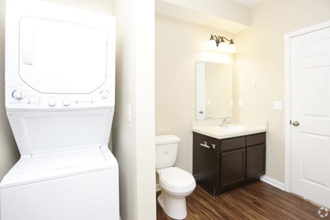 A white toilet and sink in a bathroom.
