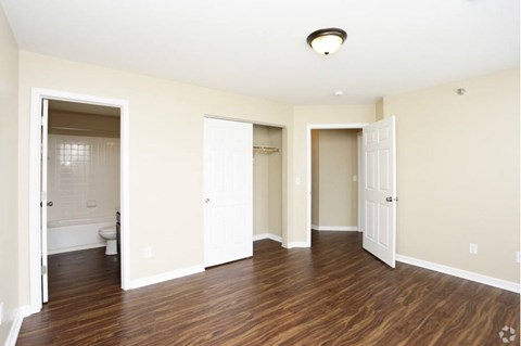 A room with wooden floors and white walls.