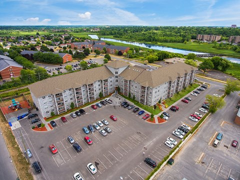 an aerial view of an apartment building and parking lot