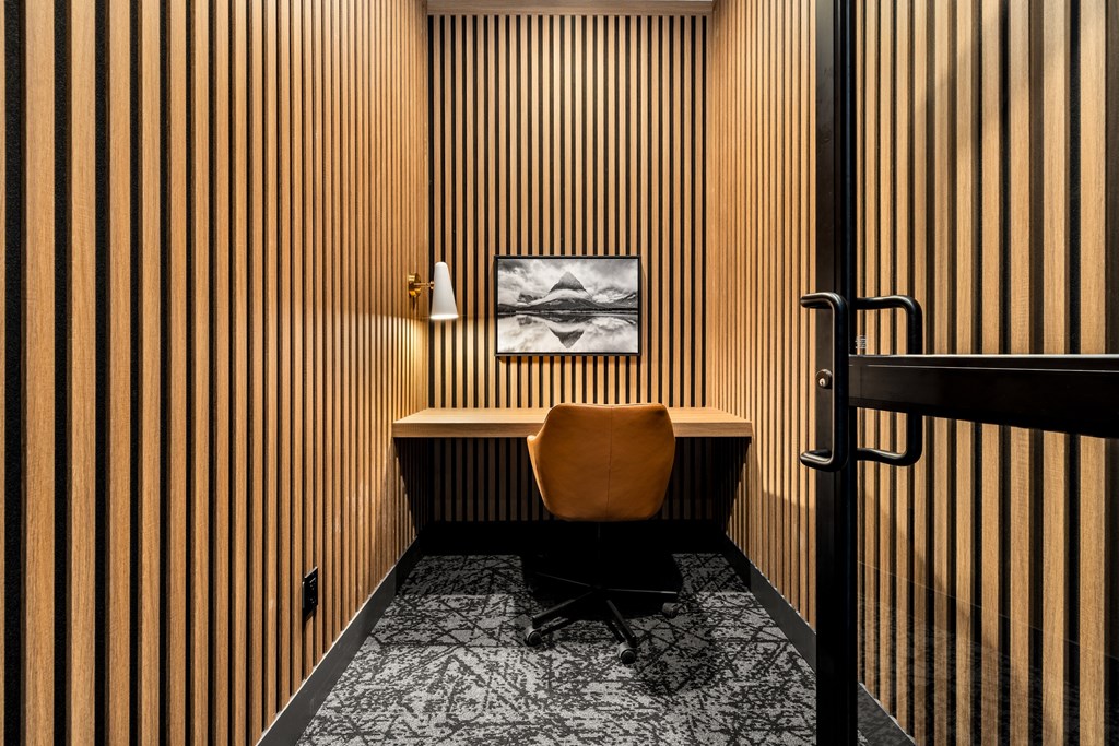 A room with a wooden wall and a chair.