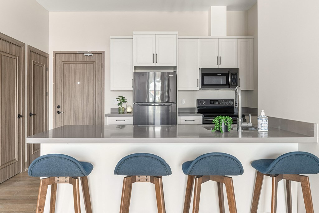 a kitchen with a counter top with four stools at 2274 Princess St., Ontario
