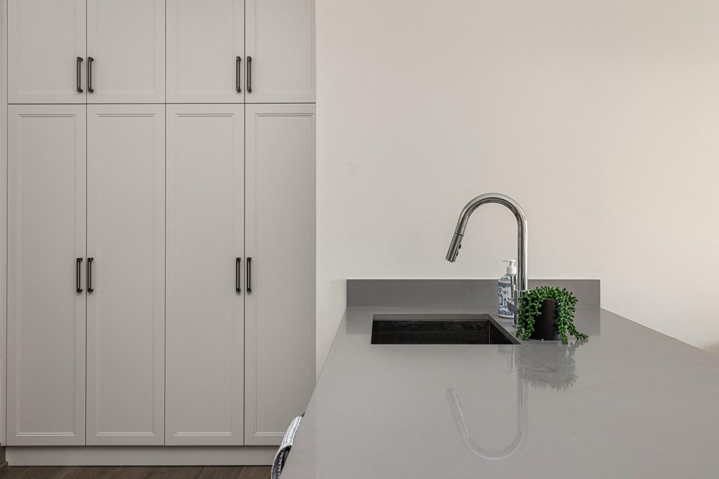 a kitchen with white cabinets and a sink and a faucet at 2274 Princess St., Ontario, K7M 3G4