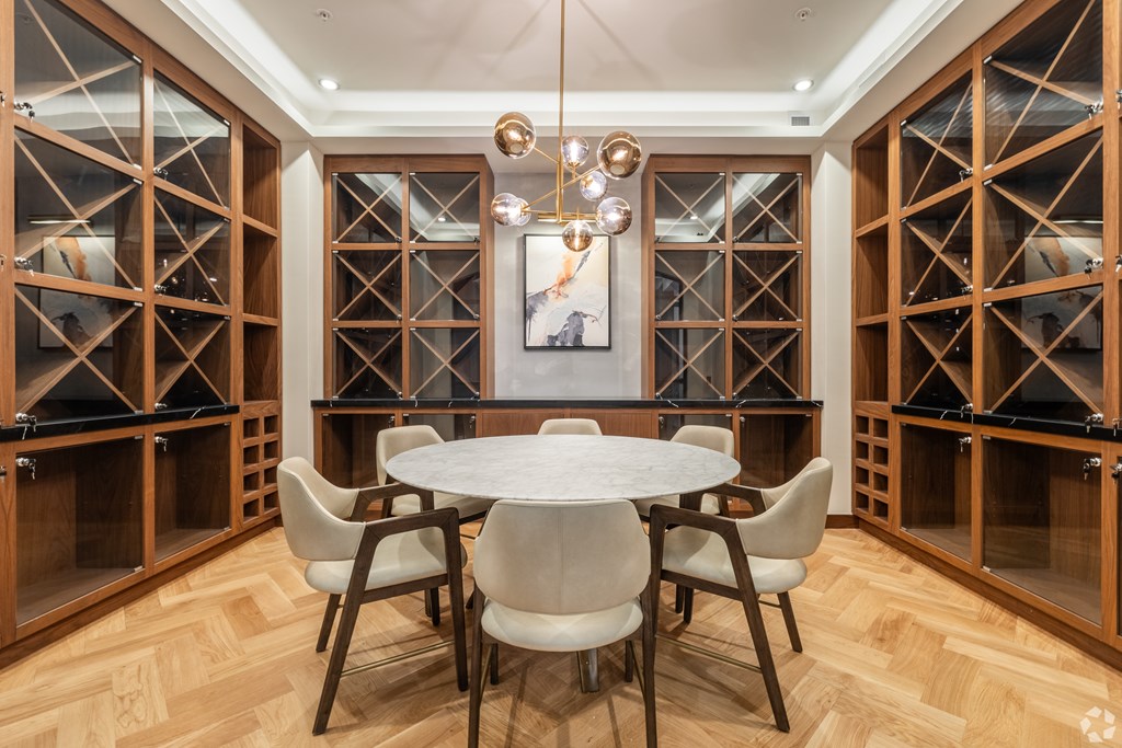 A dining room with a round table and chairs.