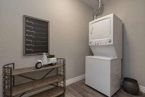 A white oven is in a kitchen next to a shelf with a chalkboard on the wall.