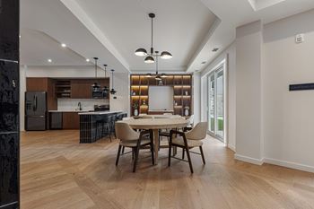 A modern dining room with a wooden table and chairs