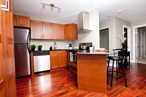 a kitchen with wooden cabinets and stainless steel appliances
