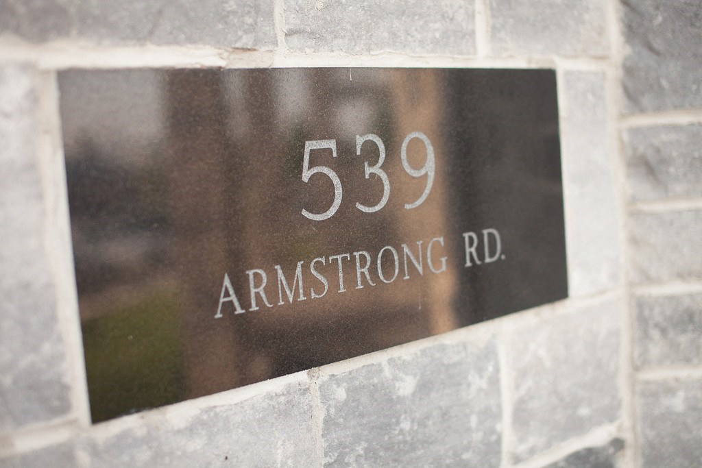 a metal sign on the side of a brick building