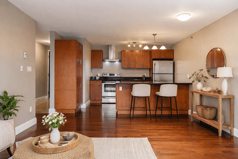 A kitchen with wooden cabinets and a white refrigerator.