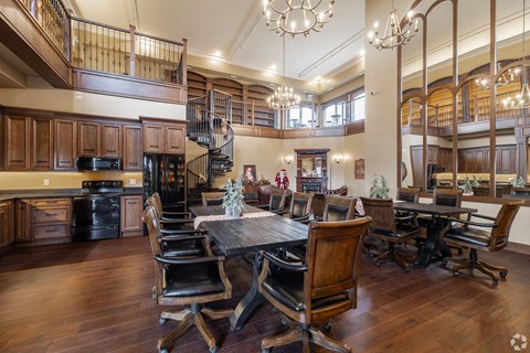 A large dining room with a wooden table and chairs.