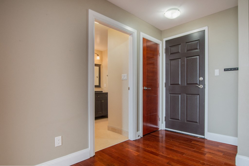 a living room with a door to a bedroom and a bathroom