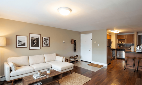A living room with a white couch and a coffee table.