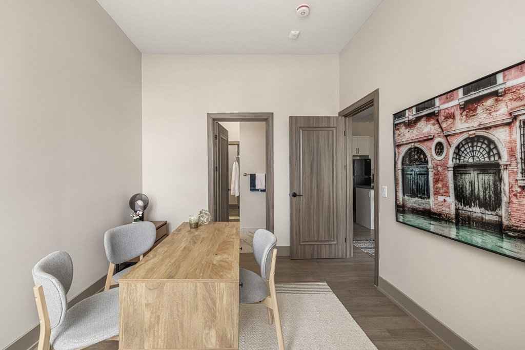 a dining area with a wooden table and chairs and a large painting on the wall at 2274 Princess St., Kingston