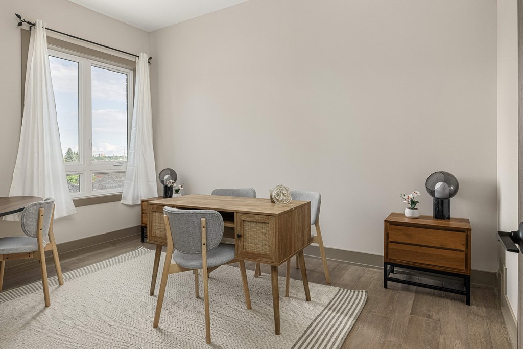 a dining area with a wooden table and two chairs at 2274 Princess St., Ontario, K7M 3G4