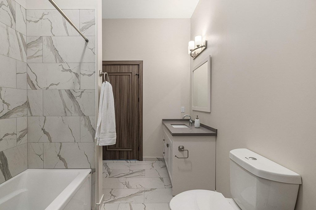 a bathroom with a toilet sink and bathtub at 2274 Princess St., Ontario, K7M 3G4