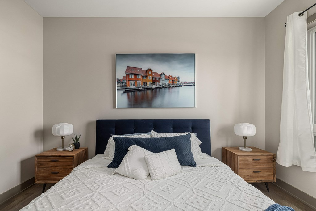 a bedroom with a large bed and two night stands with lamps at 2274 Princess St., Ontario