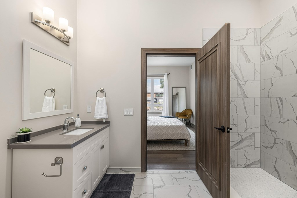 a bathroom with a shower and a bed in the background at 2274 Princess St., Kingston, Ontario