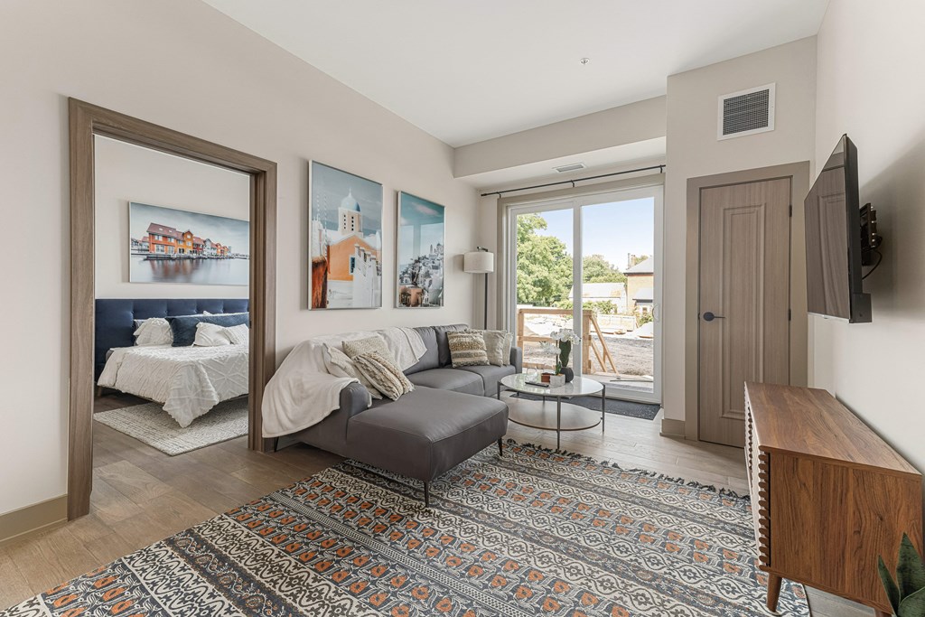 a living room with a gray couch and a large rug at 2274 Princess St., Kingston, K7M 3G4
