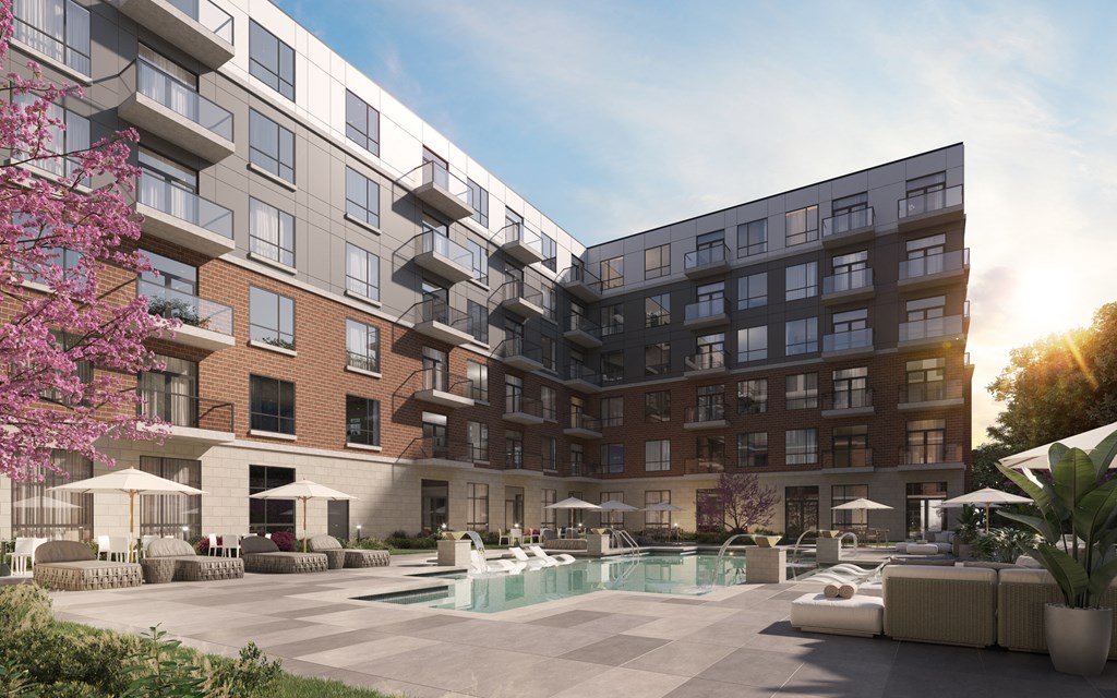 A modern apartment complex with a pool and outdoor seating area at The Woods at 180 Kanata Avenue, Kanata, Ontario