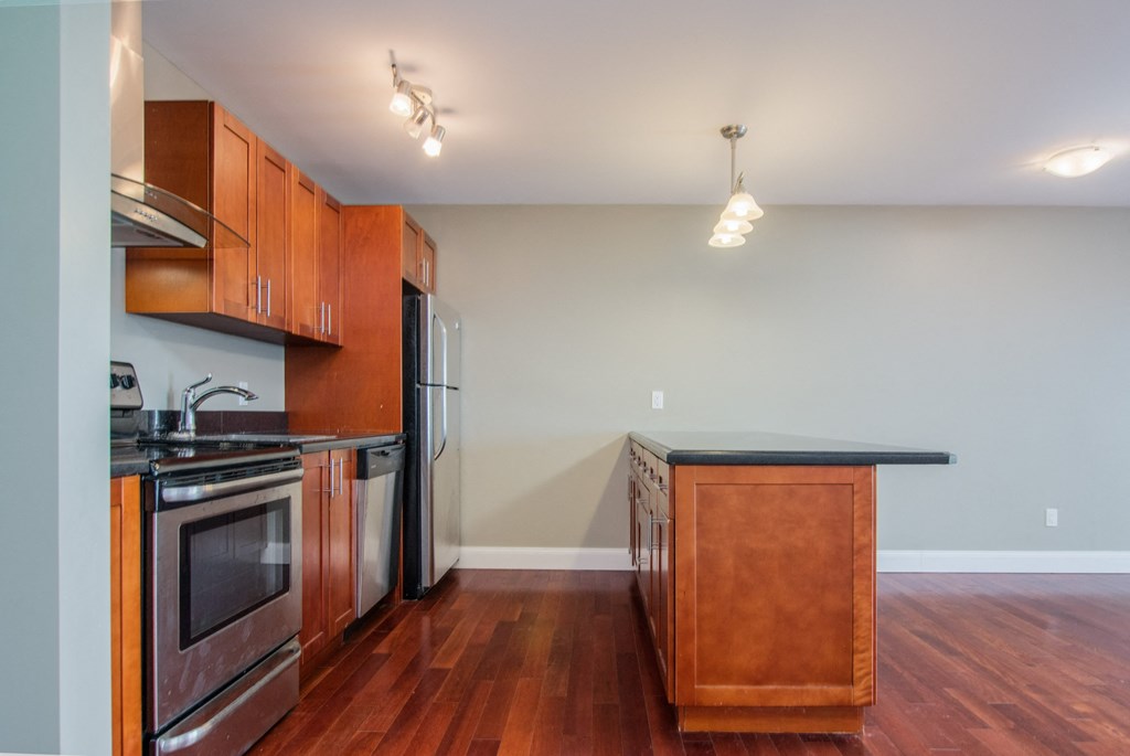 a kitchen with wooden cabinets and stainless steel appliances