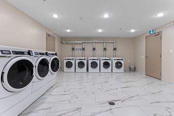 A row of washing machines in a laundromat.